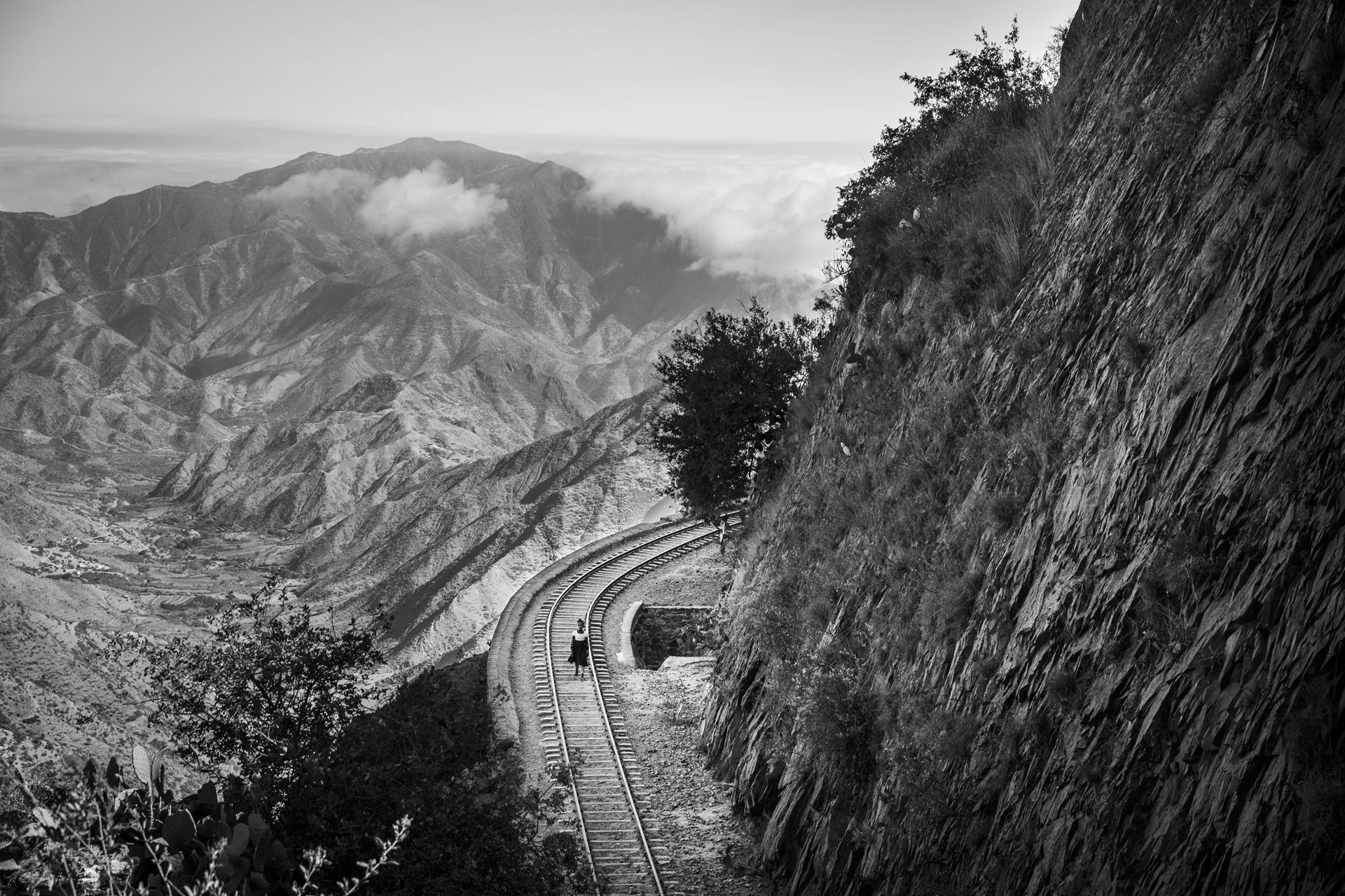 An Eritrean girl walks along the railway connecting Eritrea to Ethiopia. Many Eritrean children grow up without a parental presence because their parents have either emigrated or are serving in the military. As a result, these children feel compelled to leave and seek a new life abroad, often attempting to reunite with parents who have already left.